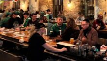 People drinking beer in bar.