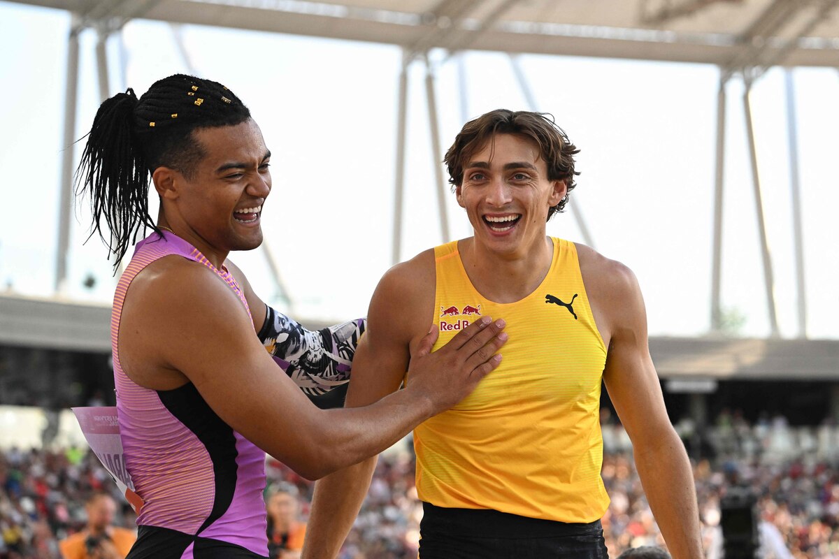 Sweden's Armand Duplantis (R) reacts with Greece's Emmanouil Karalis (L) after a jump during the men's pole vault event of the Hungarian Athletics Grand Prix in Budapest, Hungary on August 12, 2025. (Photo by Attila KISBENEDEK / AFP)