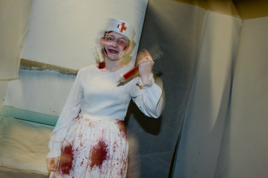 DCC-L-HAUNTED_1MJ4057 Giustina Iannetta, playing the role of a nurse, poses for a portrait inside the haunted house at Boulder High School on Thursday. Research at CU Boulder focused on how people react differently to being scared. (Matthew Jonas/Staff Photographer)